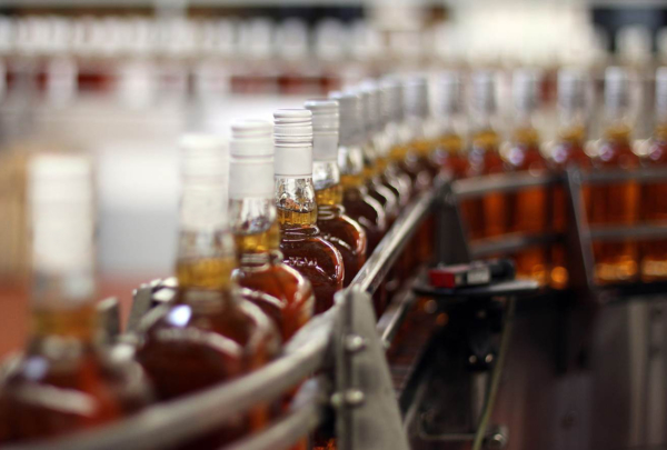 Bottles of distilled spirits on bottling line.