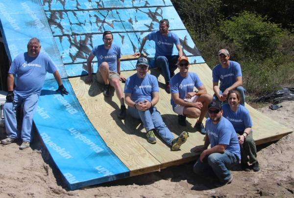 Haskell's Darrell Purkey posing with colleagues on structure outdoors.