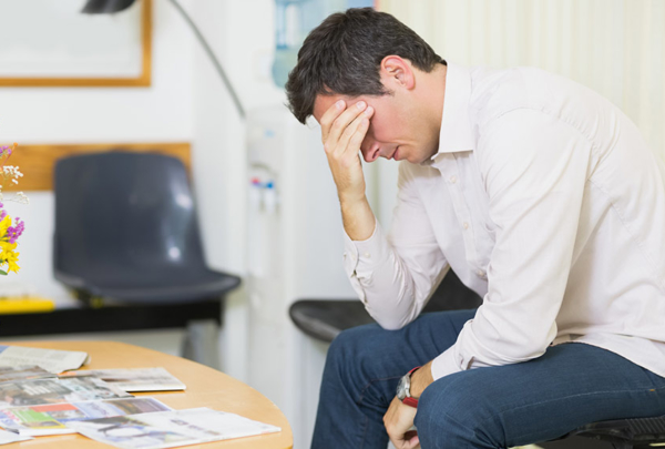 Exasperated man in doctor's waiting room.