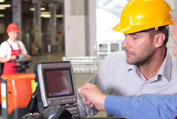 Construction workers looking at technology on a job site.