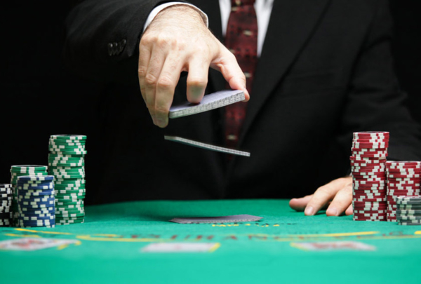 Man shuffling cards at poker table