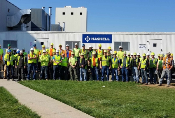 Haskell team members standing near jobsite trailer.