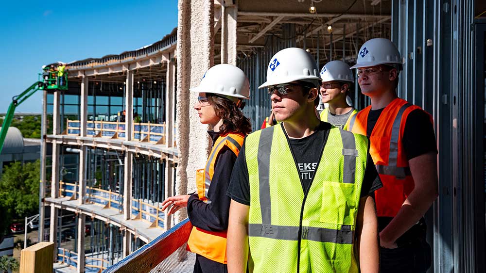 People wearing Haskell hard hats on a construction site.