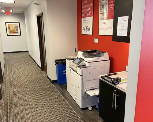 Hallway with printer station in the Fort Myers office