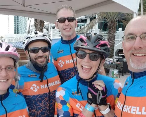 Group of Haskell team members pose in cycling gear