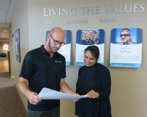 St. Louis employees discussing printed materials