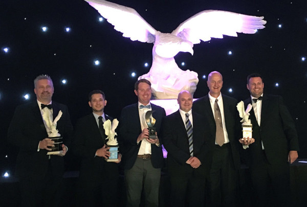 Haskell team members pose with awards.