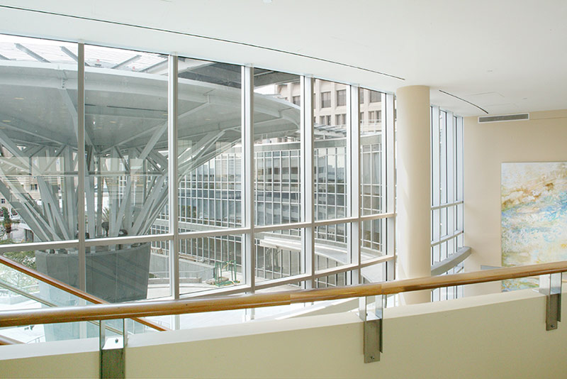 Interior photo of Baptist Heart Hospital, looking out window and over balcony.