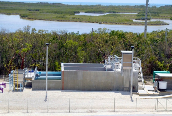 Looking down at the Layton wastewater treatment system. Purple and blue pipes extend out of the ground and system.