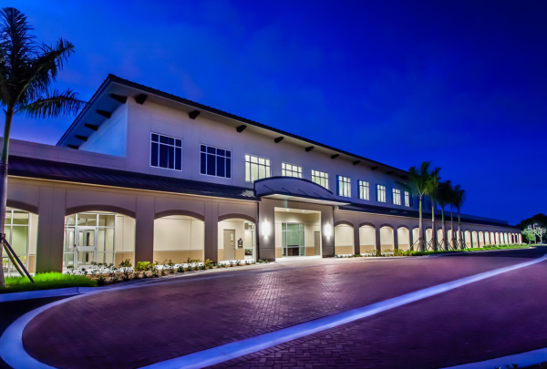 Exterior photo of LeeSar Regional Service Center at dusk. Red brick entry drive.