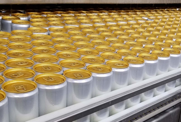 Filled seltzer cans await labeling