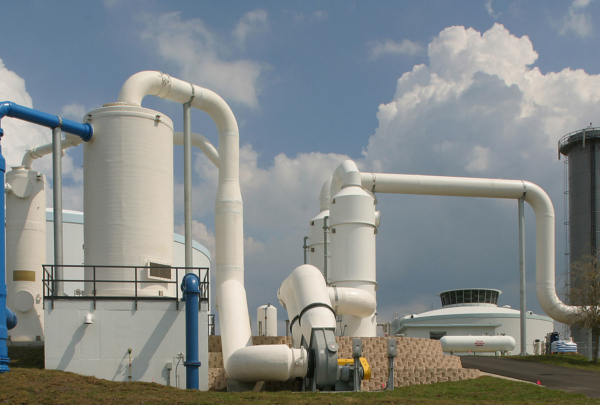 Large white storage tanks and piping outside the SMRU Water Treatment Facility